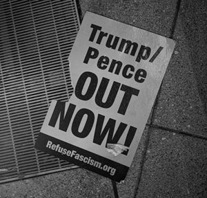 Torn Poster saying, "Trump/Pence out now!"